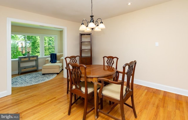 921 Coopertown Rd, Bryn Mawr, PA 19010 - dining room with a chandelier, light wood-style flooring, and baseboards