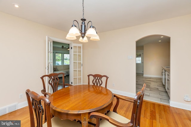 921 Coopertown Rd, Bryn Mawr, PA 19010 - dining area with arched walkways, a chandelier, light wood finished floors, baseboards, and recessed lighting