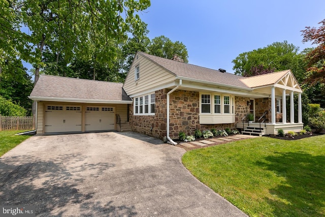921 Coopertown Rd, Bryn Mawr, PA 19010 - view of front facade with driveway, covered porch, stone siding, and an attached garage