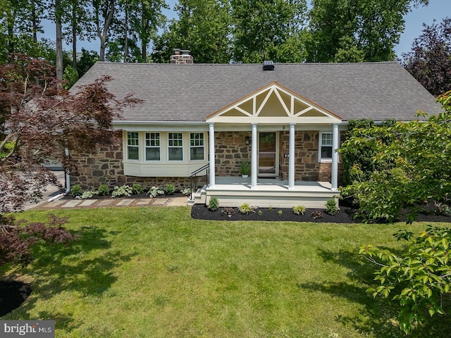 921 Coopertown Rd, Bryn Mawr, PA 19010 - view of front of property featuring covered porch, stone siding, roof with shingles, a front lawn, and a chimney