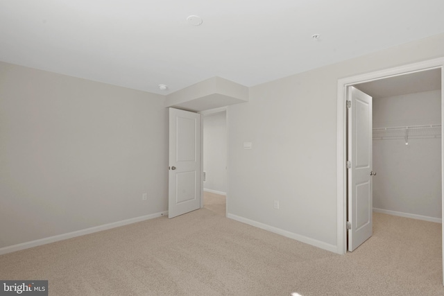 475 Ensemble Way, Frederick, MD 21701 - unfurnished bedroom with light colored carpet, baseboards, a closet, and a walk in closet