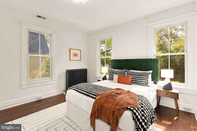 6914 6th St NW, Washington, DC 20012 - bedroom with radiator, wood finished floors, and baseboards