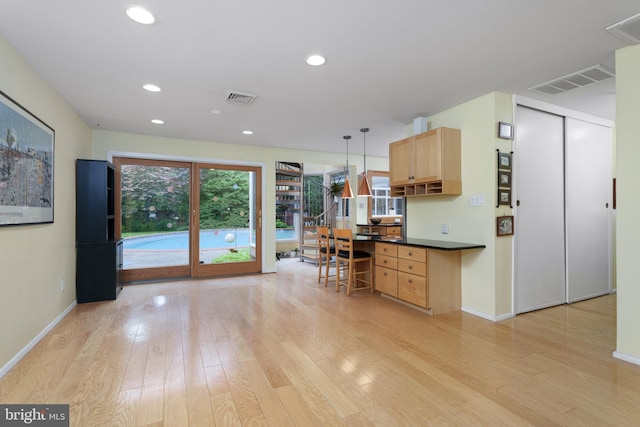 84 Cuyler Rd, Princeton, NJ 08540 - kitchen featuring dark countertops, light wood-style floors, light brown cabinetry, recessed lighting, and decorative light fixtures