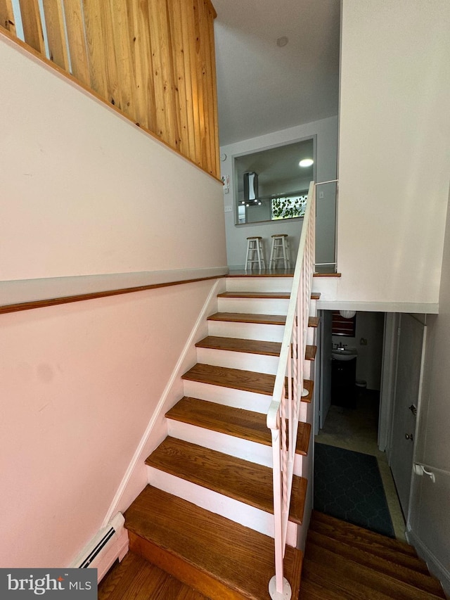 701 25th St, Huntingdon, PA 16652 - stairs featuring a baseboard heating unit and wood finished floors
