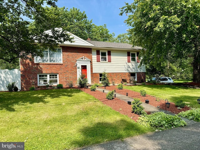 701 25th St, Huntingdon, PA 16652 - raised ranch with a front yard, brick siding, and a chimney