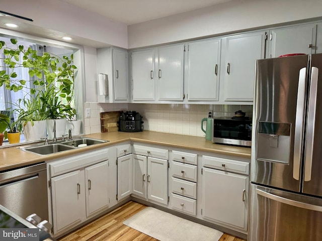 701 25th St, Huntingdon, PA 16652 - kitchen with stainless steel appliances, light countertops, tasteful backsplash, and light wood finished floors