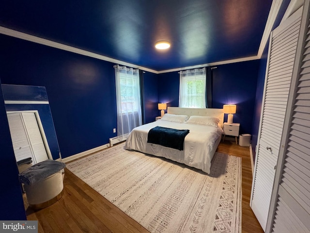 701 25th St, Huntingdon, PA 16652 - bedroom with wood finished floors, ornamental molding, baseboards, and baseboard heating