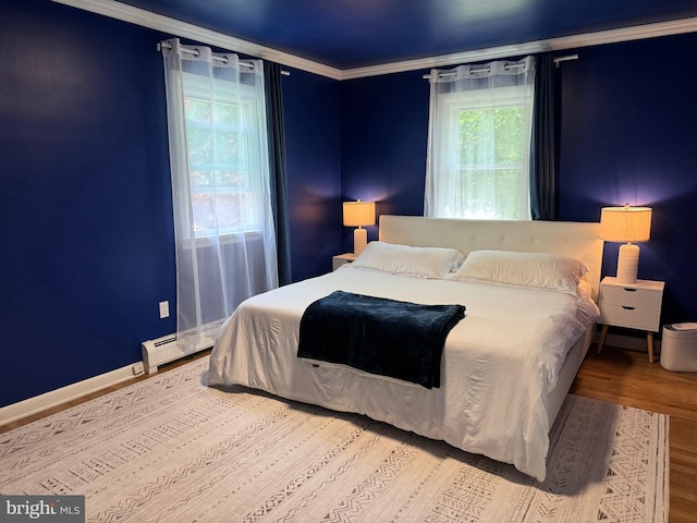 701 25th St, Huntingdon, PA 16652 - bedroom featuring wood finished floors, crown molding, a baseboard radiator, and baseboards