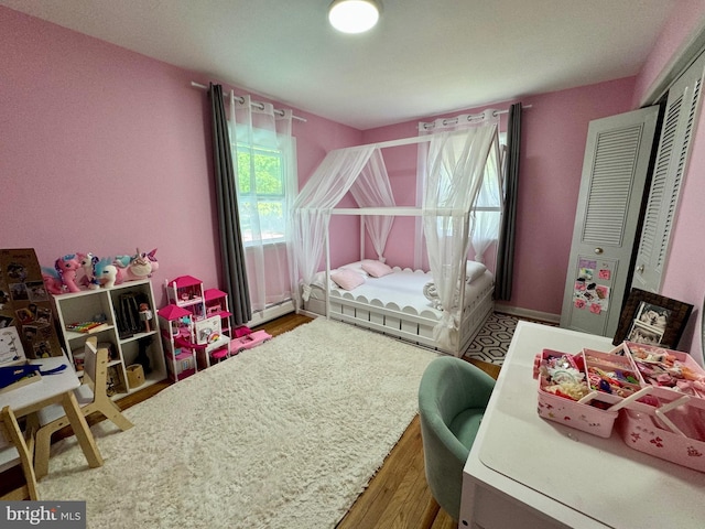 701 25th St, Huntingdon, PA 16652 - bedroom featuring a baseboard radiator and wood finished floors