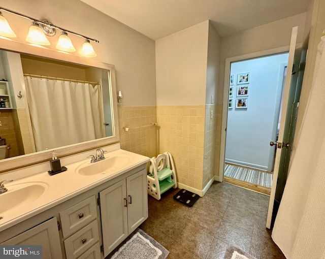 701 25th St, Huntingdon, PA 16652 - full bath with double vanity, tile walls, wainscoting, and tile patterned floors