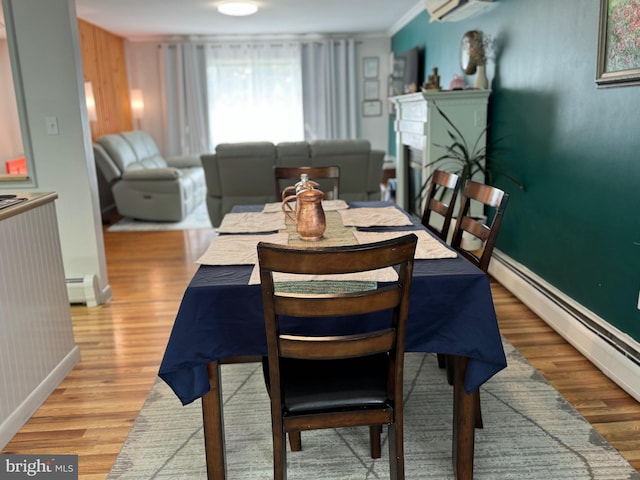 701 25th St, Huntingdon, PA 16652 - dining area with baseboards, a baseboard radiator, light wood-style flooring, a fireplace, and ornamental molding