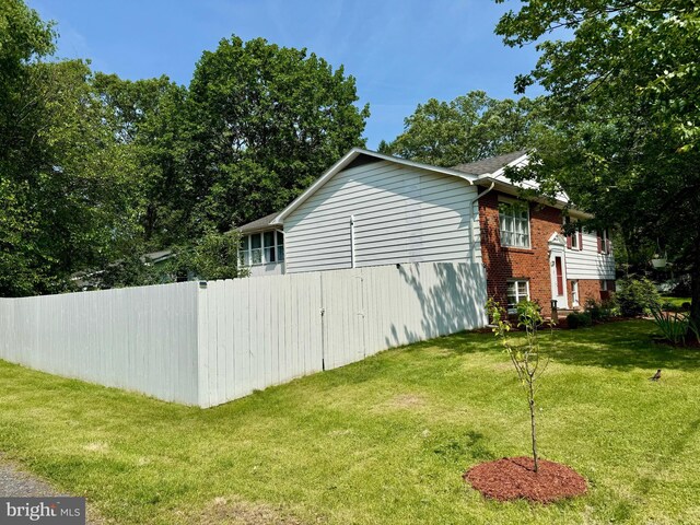701 25th St, Huntingdon, PA 16652 - view of home's exterior featuring brick siding and a lawn