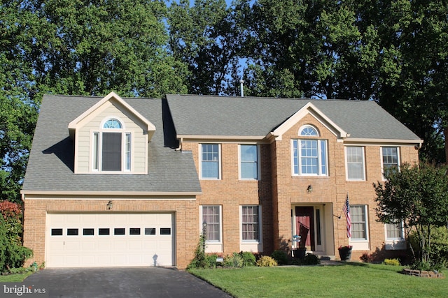 13468 Bregman Rd, Silver Spring, MD 20904 - view of front facade featuring driveway, a front lawn, brick siding, roof with shingles, and a garage