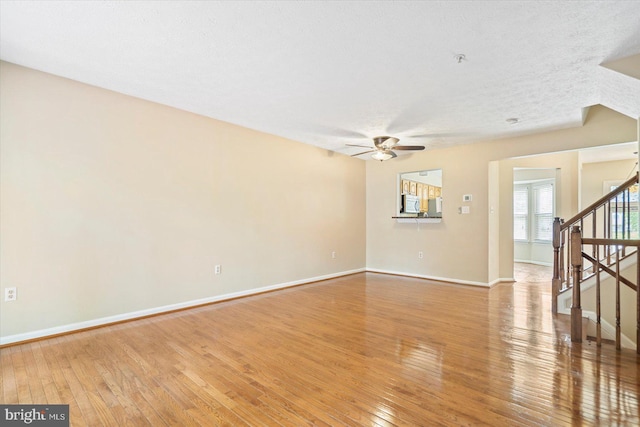 205 Quiet Ridge Ct, Pasadena, MD 21122 - unfurnished room featuring a ceiling fan, stairs, and hardwood / wood-style flooring