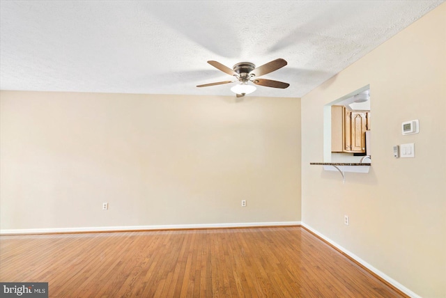 205 Quiet Ridge Ct, Pasadena, MD 21122 - empty room with a ceiling fan, baseboards, light wood-type flooring, and a textured ceiling