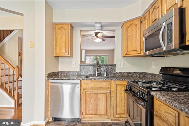 205 Quiet Ridge Ct, Pasadena, MD 21122 - kitchen featuring appliances with stainless steel finishes, a sink, a ceiling fan, and dark stone counters
