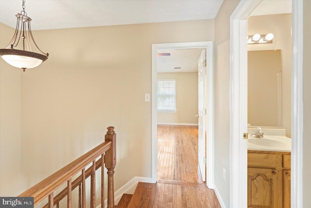 205 Quiet Ridge Ct, Pasadena, MD 21122 - corridor featuring a sink, an upstairs landing, light wood finished floors, and baseboards