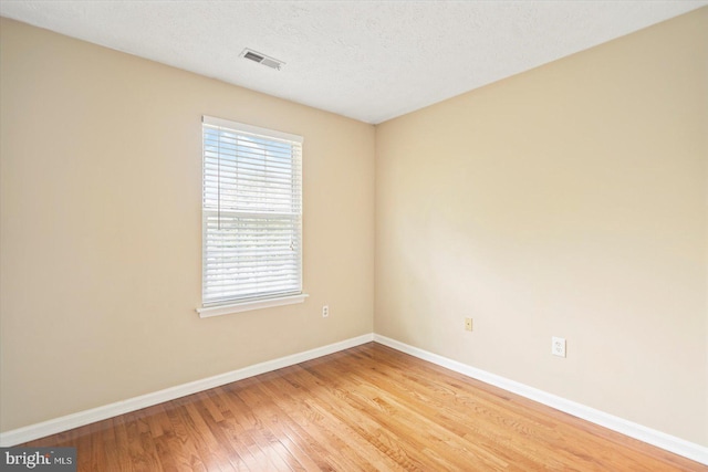 205 Quiet Ridge Ct, Pasadena, MD 21122 - spare room with light wood finished floors, baseboards, and a textured ceiling