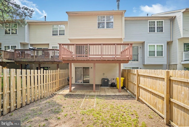 205 Quiet Ridge Ct, Pasadena, MD 21122 - rear view of house featuring a fenced backyard, a wooden deck, and central AC unit