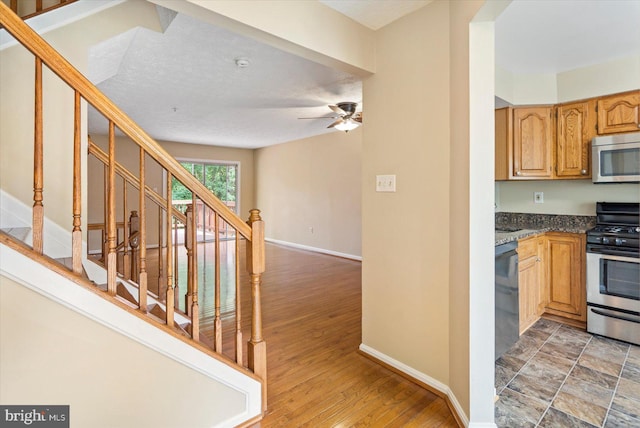205 Quiet Ridge Ct, Pasadena, MD 21122 - kitchen with stainless steel appliances, baseboards, dark countertops, and ceiling fan