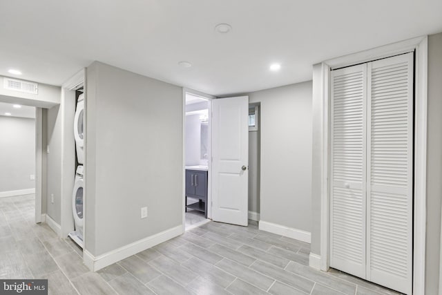 844 51st St NE, Washington, DC 20019 - finished below grade area featuring stacked washer / drying machine, baseboards, light wood-style floors, and recessed lighting