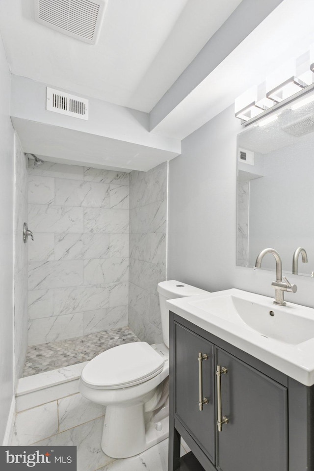 844 51st St NE, Washington, DC 20019 - full bath with marble look tile flooring, vanity, a stall shower, and toilet