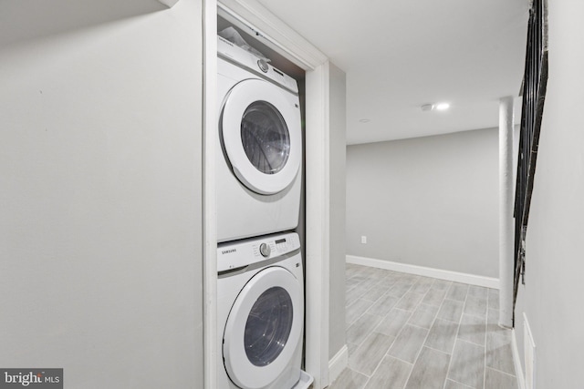844 51st St NE, Washington, DC 20019 - laundry area featuring stacked washer and clothes dryer, baseboards, recessed lighting, and light wood-style flooring