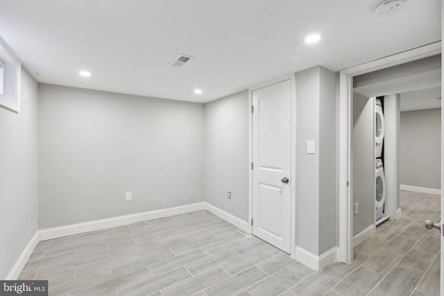 844 51st St NE, Washington, DC 20019 - finished below grade area with stacked washer / dryer, baseboards, recessed lighting, and light wood-style floors