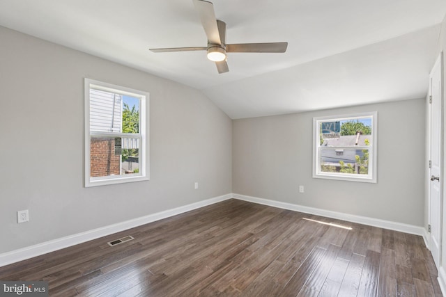 844 51st St NE, Washington, DC 20019 - spare room featuring plenty of natural light, a ceiling fan, dark wood-style flooring, vaulted ceiling, and baseboards
