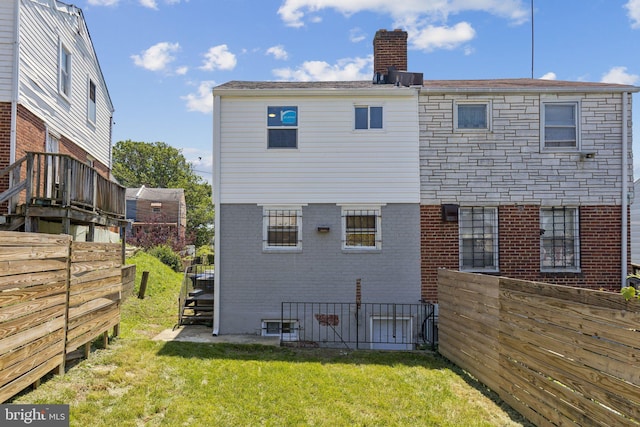 844 51st St NE, Washington, DC 20019 - rear view of property featuring brick siding and a chimney