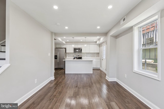 844 51st St NE, Washington, DC 20019 - unfurnished living room featuring plenty of natural light, dark wood-style flooring, baseboards, and recessed lighting