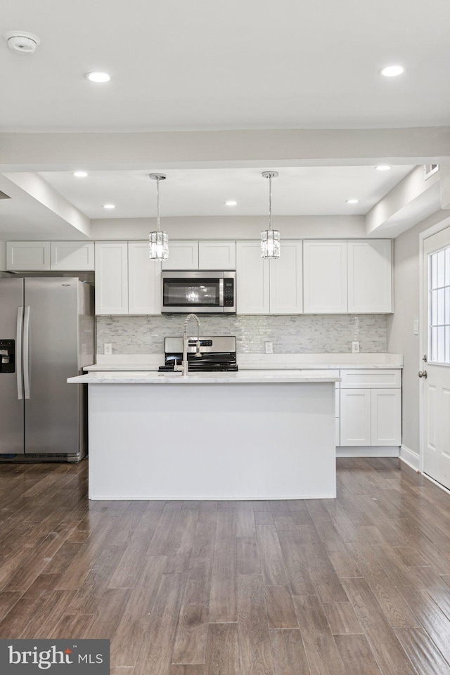 844 51st St NE, Washington, DC 20019 - kitchen with appliances with stainless steel finishes, light countertops, dark wood-style floors, decorative light fixtures, and recessed lighting