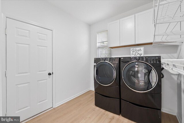 21788 Regents Park Cir, Sterling, VA 20166 - laundry room with cabinet space, washing machine and dryer, light wood-style flooring, and baseboards