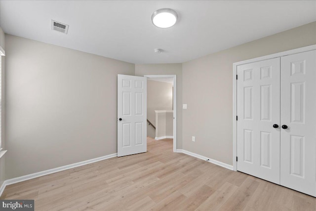 21788 Regents Park Cir, Sterling, VA 20166 - unfurnished bedroom with light wood-style flooring, a closet, and baseboards