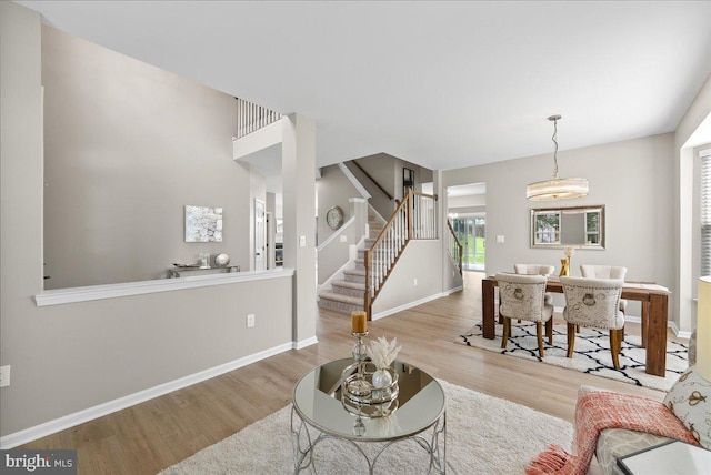 21788 Regents Park Cir, Sterling, VA 20166 - living area featuring wood finished floors, stairway, healthy amount of natural light, and baseboards