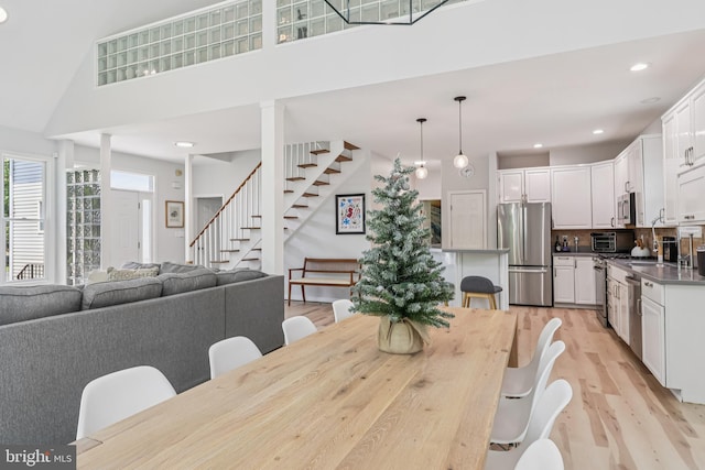 1012 Columbus Rd, Burlington, NJ 08016 - dining space with stairs, light wood-style floors, recessed lighting, and a towering ceiling