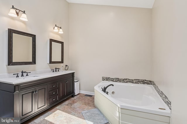 1012 Columbus Rd, Burlington, NJ 08016 - bathroom with a tub with jets, double vanity, baseboards, and stone finish flooring