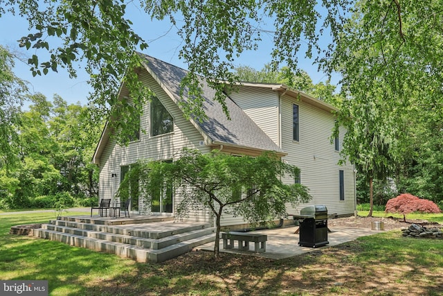 1012 Columbus Rd, Burlington, NJ 08016 - view of side of home with a patio area, a yard, and roof with shingles