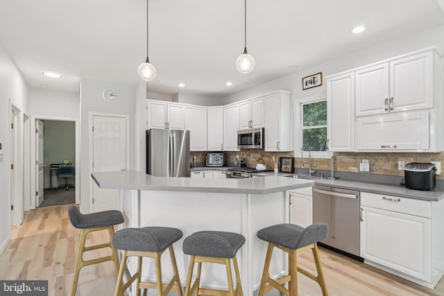 1012 Columbus Rd, Burlington, NJ 08016 - kitchen featuring stainless steel appliances, a breakfast bar area, tasteful backsplash, white cabinets, and recessed lighting