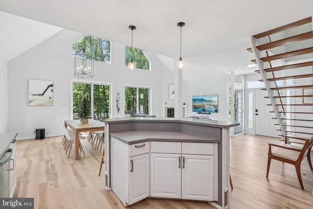 1012 Columbus Rd, Burlington, NJ 08016 - kitchen featuring dark countertops, light wood-type flooring, white cabinets, open floor plan, and pendant lighting