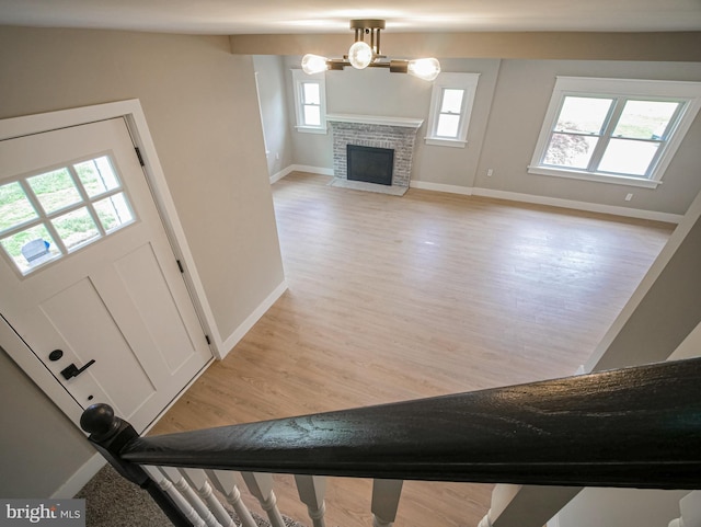 1200 First Ave, Media, PA 19063 - foyer entrance featuring light wood finished floors, a fireplace, and a chandelier