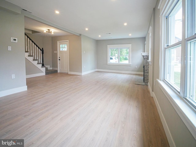1200 First Ave, Media, PA 19063 - unfurnished living room featuring stairs, light wood finished floors, a fireplace with flush hearth, and recessed lighting