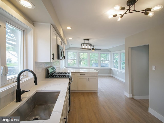 1200 First Ave, Media, PA 19063 - kitchen with appliances with stainless steel finishes, light wood-style floors, white cabinets, light stone counters, and vaulted ceiling