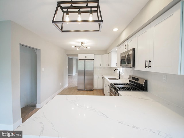 1200 First Ave, Media, PA 19063 - kitchen with stainless steel appliances, light stone countertops, decorative backsplash, white cabinetry, and recessed lighting