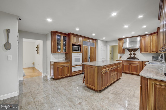 3 Monroe Ct, Plainsboro, NJ 08536 - kitchen featuring oven, a warming drawer, wall chimney exhaust hood, stainless steel microwave, and baseboards