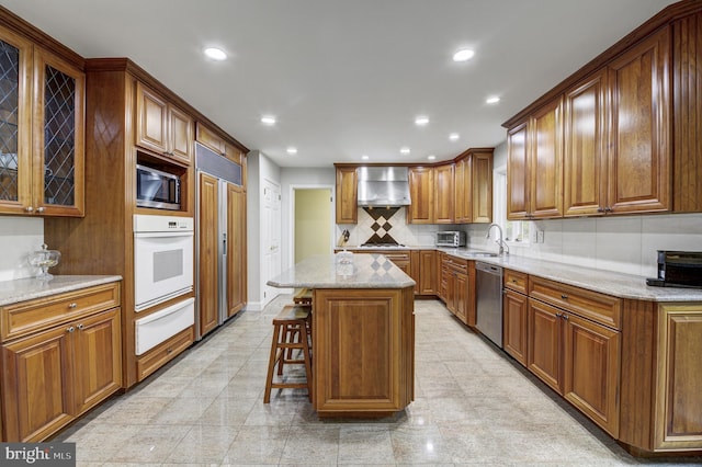 3 Monroe Ct, Plainsboro, NJ 08536 - kitchen featuring stainless steel appliances, a warming drawer, wall chimney range hood, a sink, and light stone counters