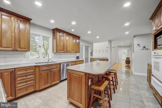 3 Monroe Ct, Plainsboro, NJ 08536 - kitchen featuring stainless steel dishwasher, a sink, white oven, a warming drawer, and a kitchen island