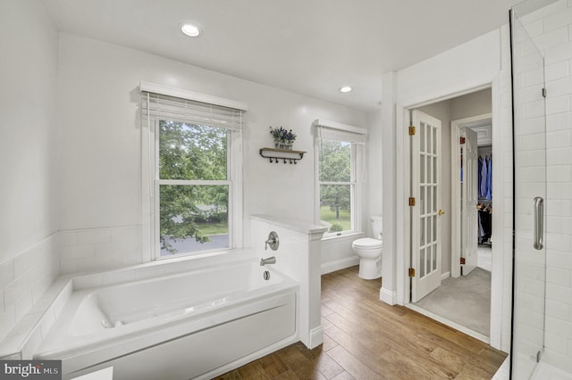 3 Monroe Ct, Plainsboro, NJ 08536 - bathroom featuring toilet, a garden tub, wood finished floors, a walk in closet, and a shower stall