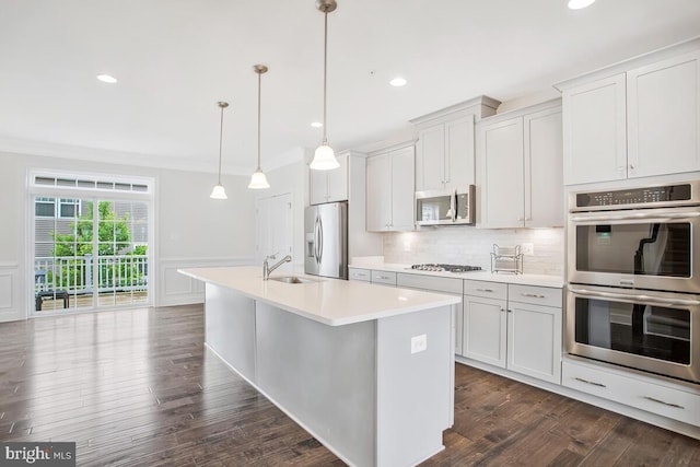 6911 Stansbury Ln, Landover, MD 20785 - kitchen with appliances with stainless steel finishes, a sink, an island with sink, light countertops, and crown molding