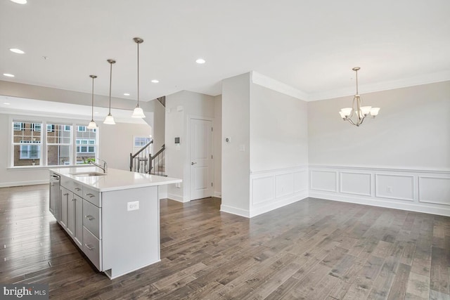 6911 Stansbury Ln, Landover, MD 20785 - kitchen with a sink, open floor plan, dark wood-style flooring, light countertops, and a chandelier